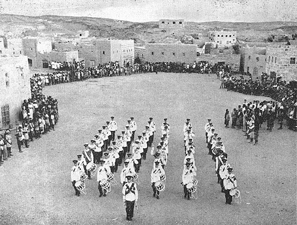 Band and Drums, 1st Bn The Queen's Royal Surrey Regiment Beat Retreat at Mukeiras on Yemen border.