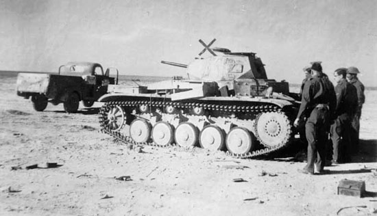 Members of 2nd Queen's inspecting an enemy tank.